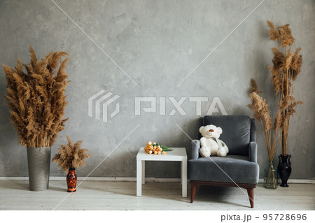 room with an armchair and dried flowers room with an armchair and dried flowers 95728696