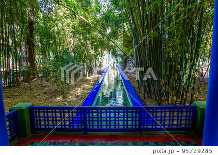 View from blue gazebo on canal and bamboo forest in Majorelle garden in Marracech 95729285