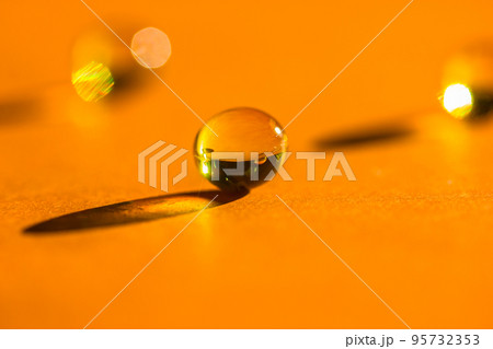 Yellow vitamins aevit, fish oil pills, omega 3 gelatin capsules, round tablets lie on orange table leaving contrasting shadows. Medical, health care, medicine treatment. Monochrome background top view Yellow vitamins aevit, fish oil pills, omega 3 gelatin capsules, round tablets lie on orange table leaving contrasting shadows. Medical, health care, medicine treatment. Monochrome background top view 95732353