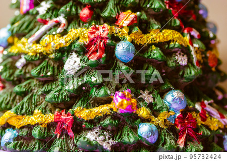 Decorative New Year's Eve beautifully decorated with garlands toys. Christmas New Year 2023 winter holidays background texture. Festive wallpaper. Happy holidays in December, January. Selective focus. 95732424