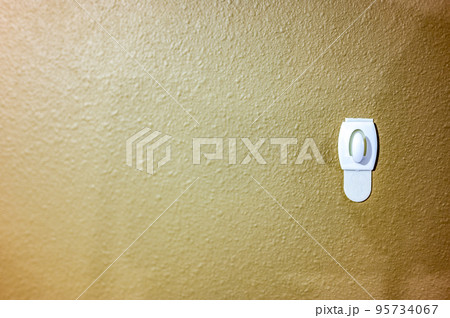 Selective focus on adhesive strip wall hanger that can be removed by pulling tape 95734067