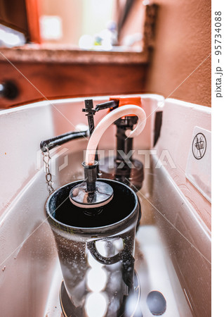 Inside water tank of toilet with float raised 95734088