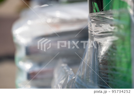Selective focus on cellophane shrink wrap on pallets of goods for transport. Selective focus on cellophane shrink wrap on pallets of goods for transport. 95734252
