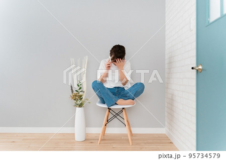 スマホで通話しながらショックを受けるアジア人女性（泣く・悲しい） 95734579