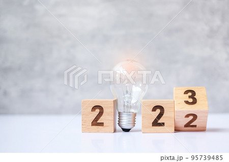 flip 2022 to 2023 block with lightbulb. Business Idea, Creative, Thinking, brainstorm, Goal, Resolution, strategy, plan, Action, change and New Year start concepts 95739485