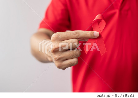 Red Ribbon for December World Aids Day, acquired immune deficiency syndrome, multiple myeloma Cancer Awareness month and National Red ribbon week. Healthcare and world cancer day concept Red Ribbon for December World Aids Day, acquired immune deficiency syndrome, multiple myeloma Cancer Awareness month and National Red ribbon week. Healthcare and world cancer day concept 95739533