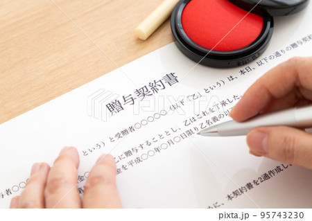 契約書にサインするミドル女性の手元 95743230