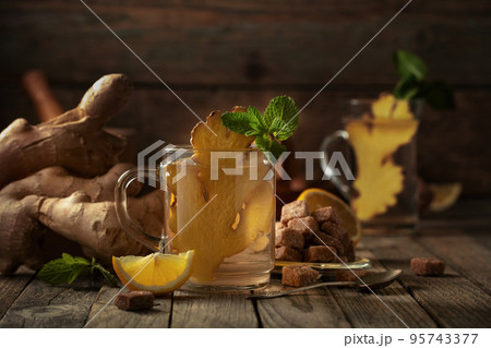 Ginger tea with lemon and mint . 95743377