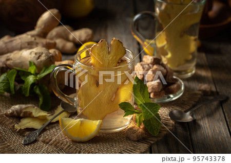 Ginger tea with lemon and mint . 95743378