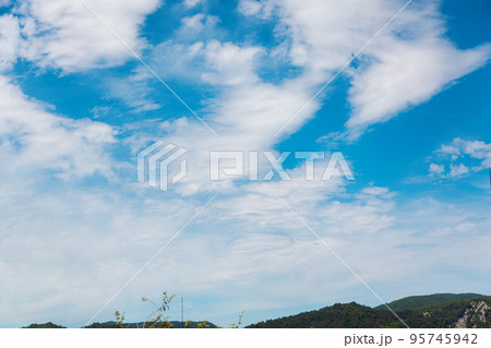 Blue sunny sky with clouds and mountains. Beautiful heaven. Peaceful and freedom concept Blue sunny sky with clouds and mountains. Beautiful heaven. Peaceful and freedom concept 95745942