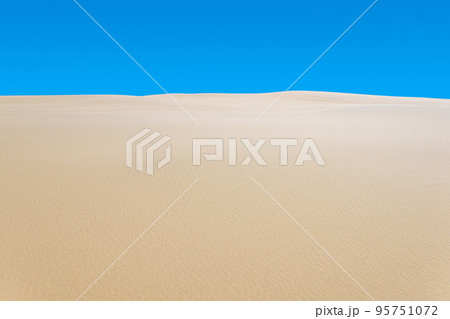 desert landscape, sand dunes under blue sky 95751072