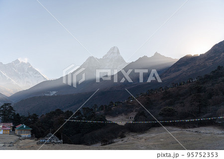 New photo of nature, high mountains on a blue sky background, Nepal. Trekkers with vew during way from Dingboche to Lobuche. 95752353