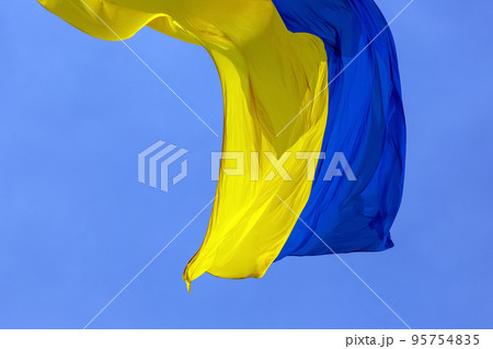waving in the wind the national flag of Ukraine against the blue sky waving in the wind the national flag of Ukraine against the blue sky 95754835