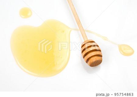 spoon with fresh honey spilled on a white background. organic vitamin food 95754863