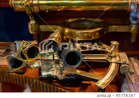 Exhibit of an old bronze sextant, close-up photo. Exhibit of an old bronze sextant, close-up photo. 95756167