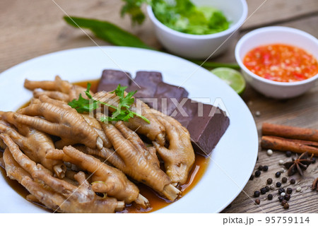 Thai food, chicken feet soup stewed, cooking chicken feet foot stew on white with herbs and spices ingredients with chilli lemon vegetable on wooden background, Asian chinese food menu stew 95759114