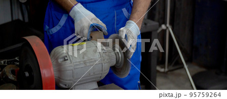 Closeup hands of young man sanding or iron at industrial factory. Closeup hands of young man sanding or iron at industrial factory. 95759264