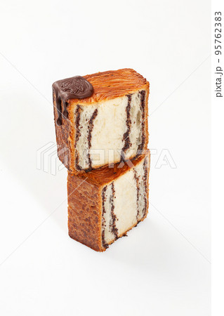 Two halves of flaky sweet cube croissant with walnut cinnamon filling and chocolate Two halves of flaky sweet cube croissant with walnut cinnamon filling and chocolate 95762383