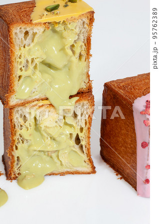 Sliced puff pastry cube shaped croissant with pistachio custard cream filling 95762389