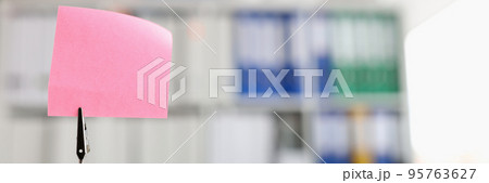 Pink blank note sticker on desk in office closeup Pink blank note sticker on desk in office closeup 95763627