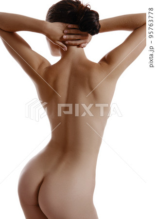 Nude, attractive woman, hands on head, posing standing back to camera, isolated on white. Plastic surgery and aesthetic cosmetology concept. Close-up. 95763778