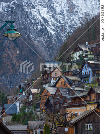 Hallstatt, a charming village on the Hallstattersee lake and a famous tourist attraction, with beautiful mountains surrounding it, in Salzkammergut region, Austria, in winter sunny day. Hallstatt, a charming village on the Hallstattersee lake and a famous tourist attraction, with beautiful mountains surrounding it, in Salzkammergut region, Austria, in winter sunny day. 95763892