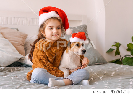 Merry Christmas and Happy New Year. Adorable little girl wearing santa claus Merry Christmas and Happy New Year. Adorable little girl wearing santa claus 95764219