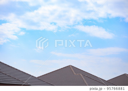 Ceramic roof tiles on the house with blue sky 95766881