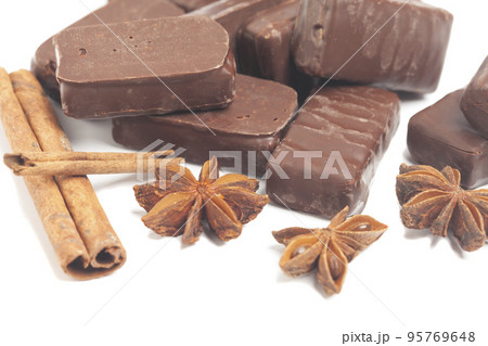 gourmet chocolate bonbons with anise and cinnamon sticks isolated on white background gourmet chocolate bonbons with anise and cinnamon sticks isolated on white background 95769648