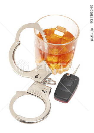 Concept for drinking and driving. Whiskey with car keys and handcuffs. Concept for drinking and driving. Whiskey with car keys and handcuffs. 95769649