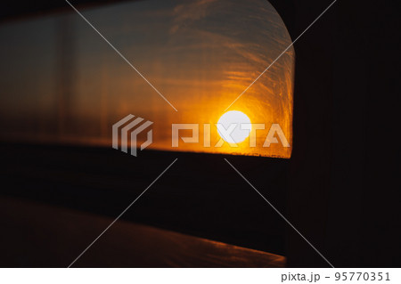 Sun at sunset through the car window 95770351