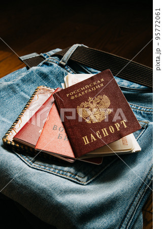 Russian documents and cash money are lying on a stick of things, the man is going to leave Russia. Russian documents and cash money are lying on a stick of things, the man is going to leave Russia. 95772061