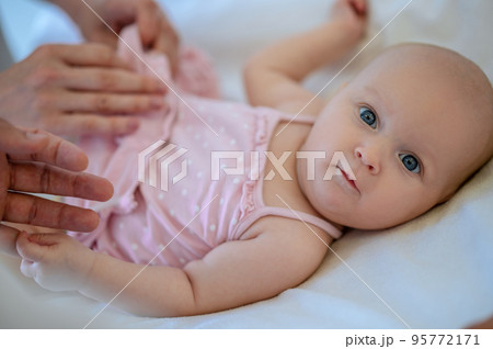 Surgeon checking babys legs for dysplasia Surgeon checking babys legs for dysplasia 95772171