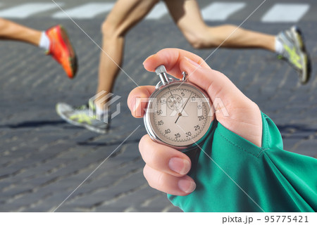measuring the running speed of an athlete using a mechanical stopwatch measuring the running speed of an athlete using a mechanical stopwatch 95775421