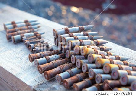old rusty cartridges in a machine-gun belt. war in Ukraine. military ammunition 95776263