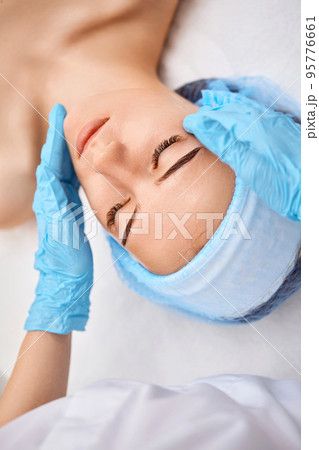 young beautiful woman receiving facial massage. spa young beautiful woman receiving facial massage. spa 95776661