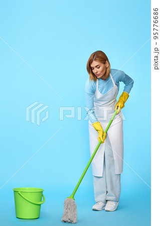 woman in rubber gloves washing floor with mop woman in rubber gloves washing floor with mop 95776686