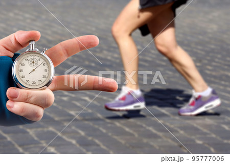 measuring the running speed of an athlete using a mechanical stopwatch measuring the running speed of an athlete using a mechanical stopwatch 95777006