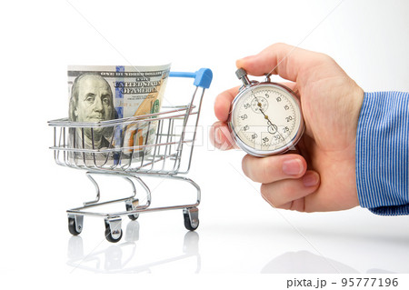 grocery basket with dollars and a stopwatch. concept of time in business grocery basket with dollars and a stopwatch. concept of time in business 95777196