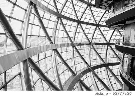 Interior and panoramic windows of round Sphere futuristic modern building. Glass roof and walls, panoramic windows, glass architecture, interior, view from below. Black and white photography. Interior and panoramic windows of round Sphere futuristic modern building. Glass roof and walls, panoramic windows, glass architecture, interior, view from below. Black and white photography. 95777250