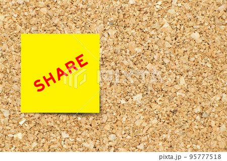 Yellow note paper with word share on cork board background with copy space 95777518