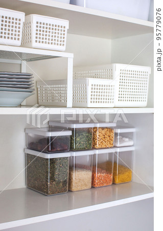Storage ideas in the kitchen. White box and basket. Shelf order system.  95779076