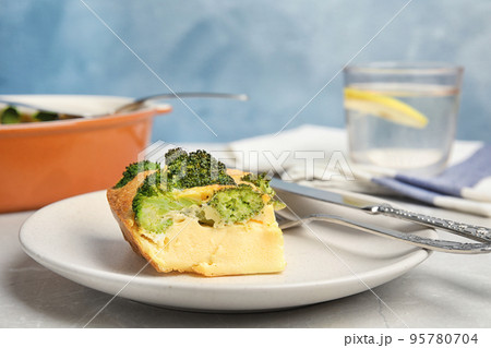 Tasty broccoli casserole served on grey marble table Tasty broccoli casserole served on grey marble table 95780704