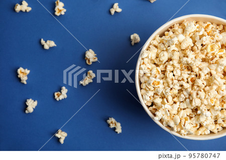 Tasty pop corn on blue background, flat lay Tasty pop corn on blue background, flat lay 95780747