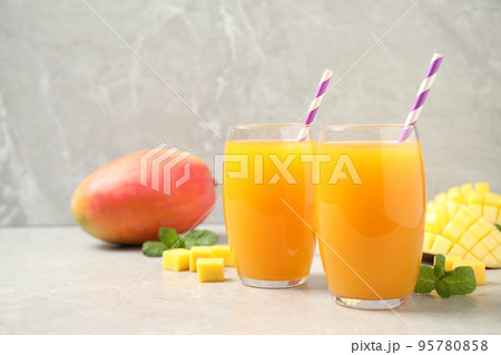 Fresh delicious mango drink on light table 95780858