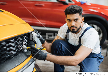 Manual cleaning with soap at car wash. Manual cleaning with soap at car wash. 95782295