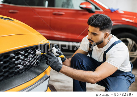 Manual cleaning with soap at car wash. 95782297