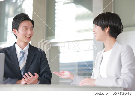 コーチング_男性管理職に今期の実績を話す女性メンバー_1 95783046