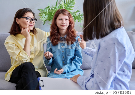 Child psychologist session, mother daughter therapist together in office Child psychologist session, mother daughter therapist together in office 95783605