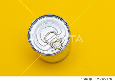 Unopened Tin Can with Blank Edge on Yellow Background Unopened Tin Can with Blank Edge on Yellow Background 95785470